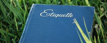 Etiquette in poker image of a blue etiquette book on grass