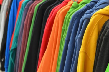 Sports Costume Ideas image of a rack of colourful sweatshirts